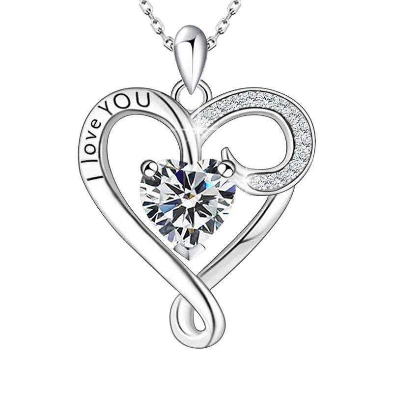 A silver infinity heart necklace with a sparkling heart-shaped birthstone at the center, engraved with “I love you,” symbolizing eternal love.