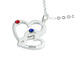 Silver heart-shaped necklace with two birthstones, one red and one blue, and engraved names 'Rong' and 'heng'.