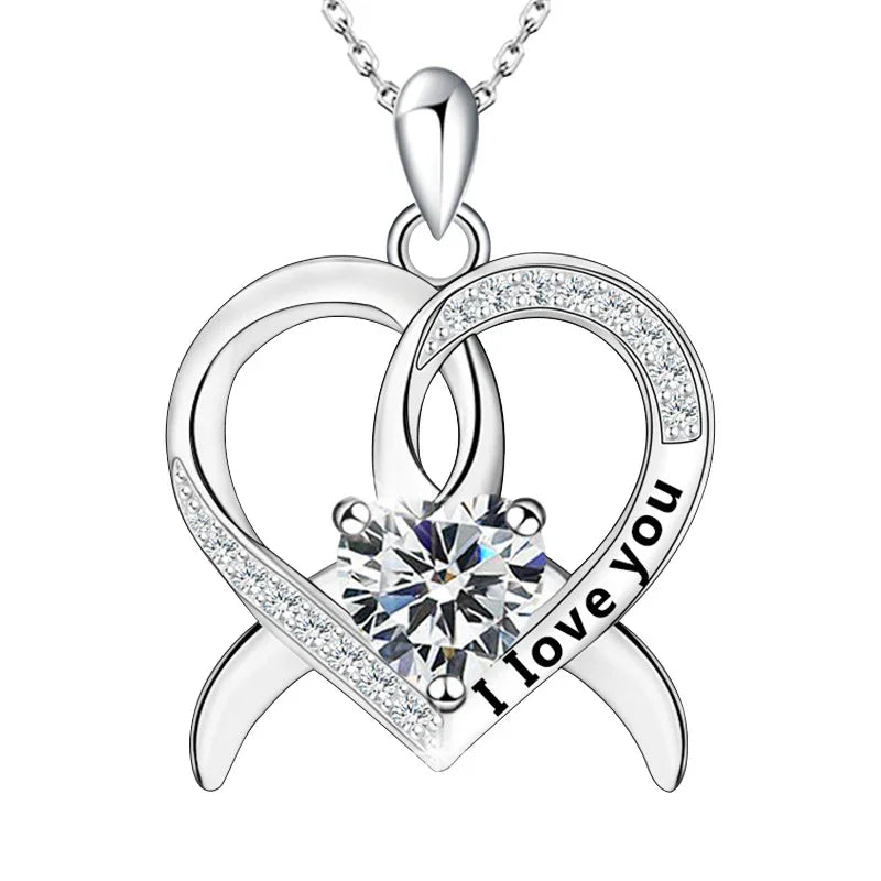 A silver double-heart necklace engraved with “I love you,” featuring a sparkling round birthstone at the center, symbolizing two hearts intertwined in love.