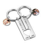 Keychain with heart-shaped tag and photo charms on a white background