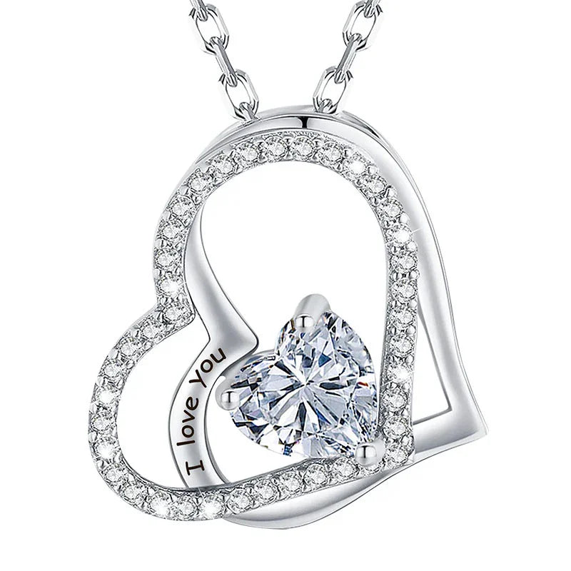Silver double-heart pendant featuring a central heart-shaped gemstone and engraved text that reads “I love you,” displayed on a white background.
