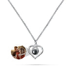 Heart-shaped pendant with a photo insert on a white background