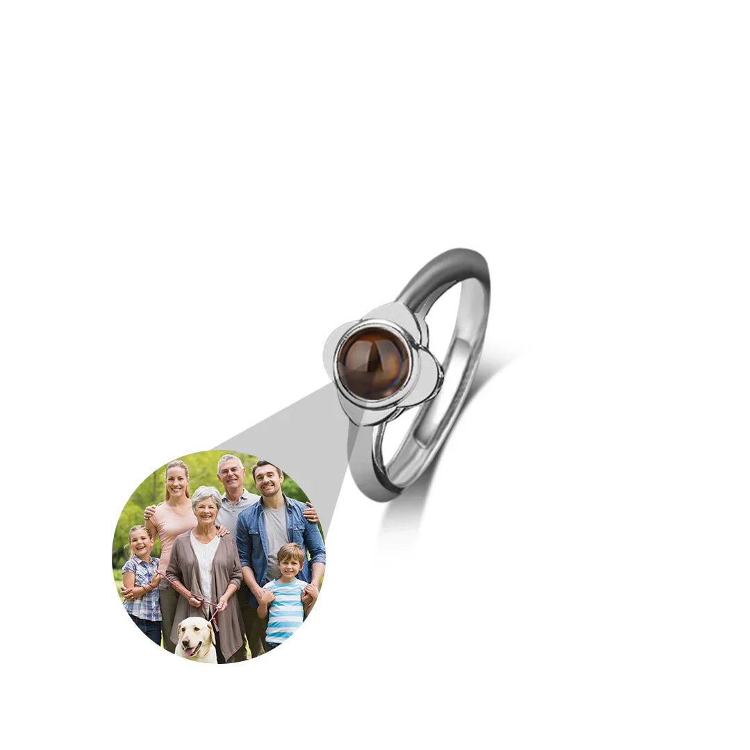 Silver ring with a brown gemstone and a photo of a family on a white background