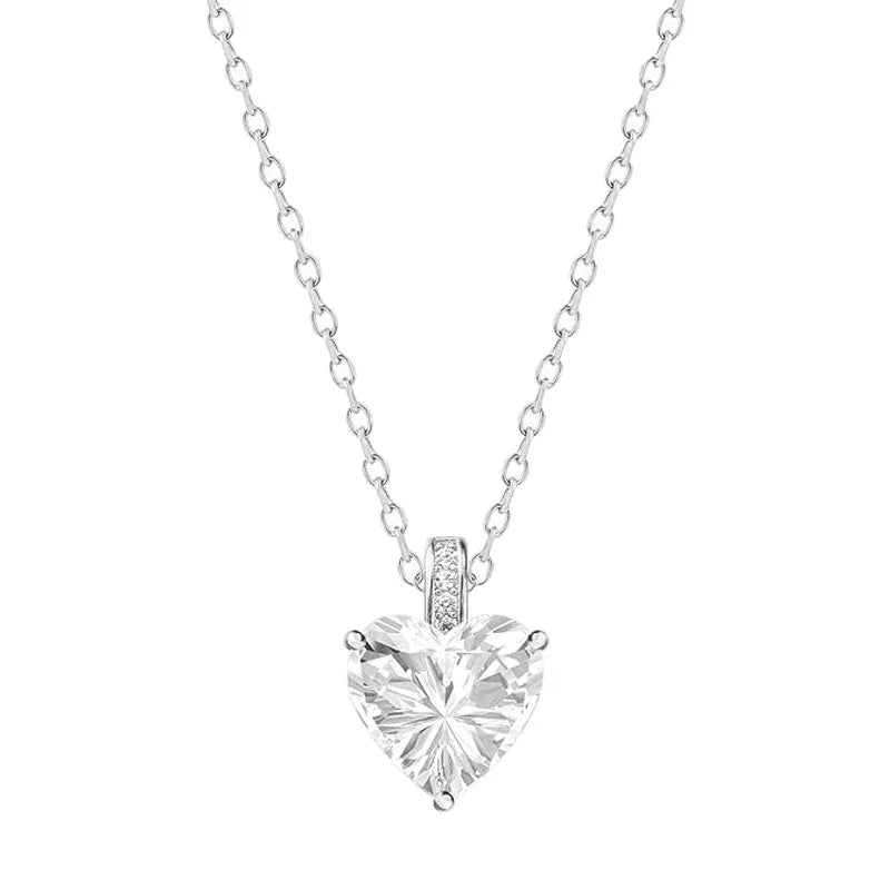 Heart-shaped diamond pendant on a chain against a white background