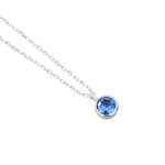 Necklace with a blue gemstone pendant on a white background
