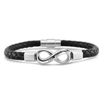 A men's bracelet featuring a braided black leather strap with a polished stainless steel infinity symbol at the center. The infinity charm has custom engraved names “Tina ♥ David” and is connected with metallic end caps and a magnetic clasp.
