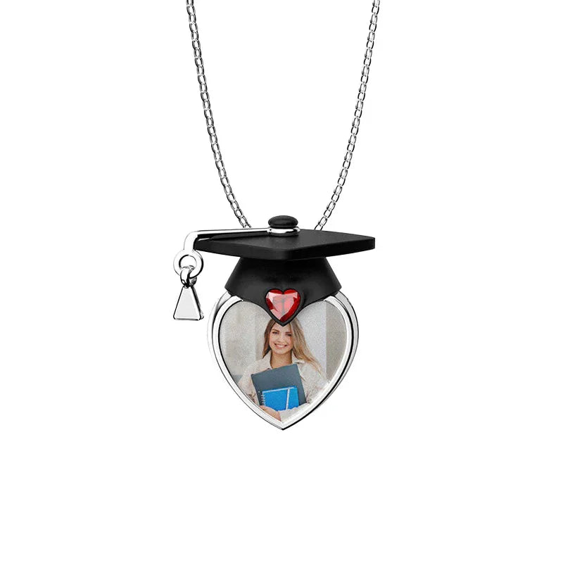 Heart-shaped photo locket with graduation cap design on a white background