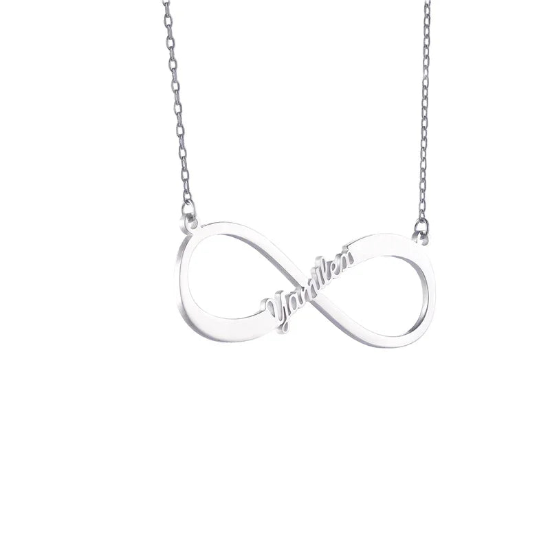 A silver infinity name necklace featuring the word “Yamilex” elegantly integrated into the infinity symbol. The pendant hangs from a delicate silver chain, showcasing a minimalist and modern design.