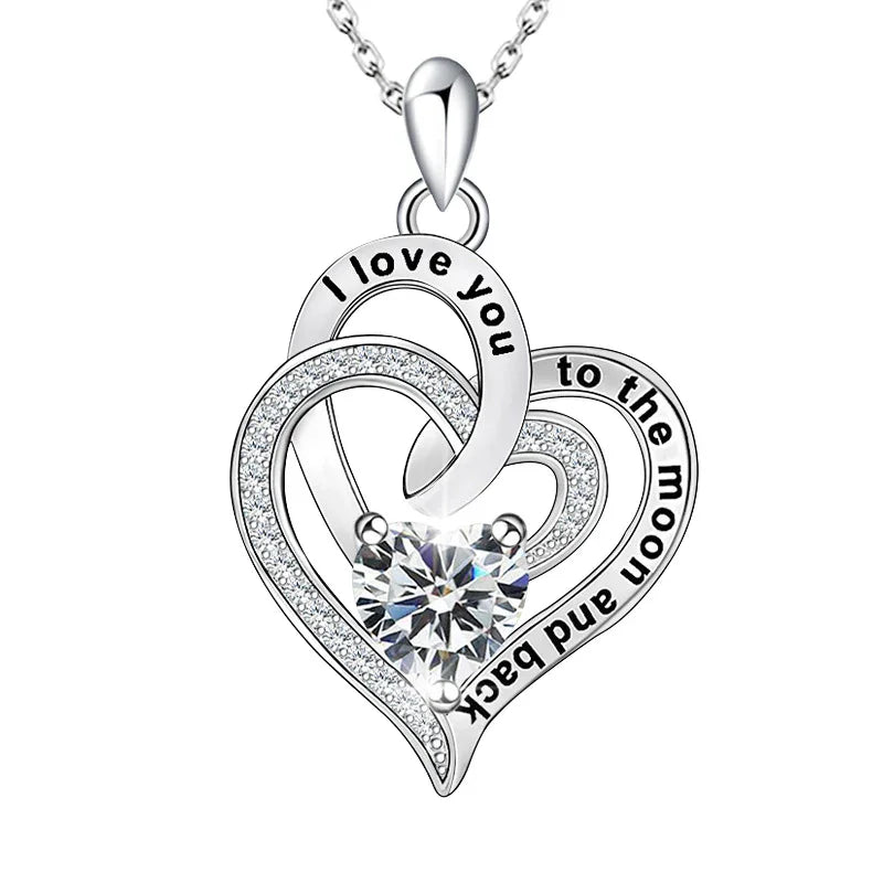 Silver heart-shaped pendant with 'I love you to the moon and back' text on a white background