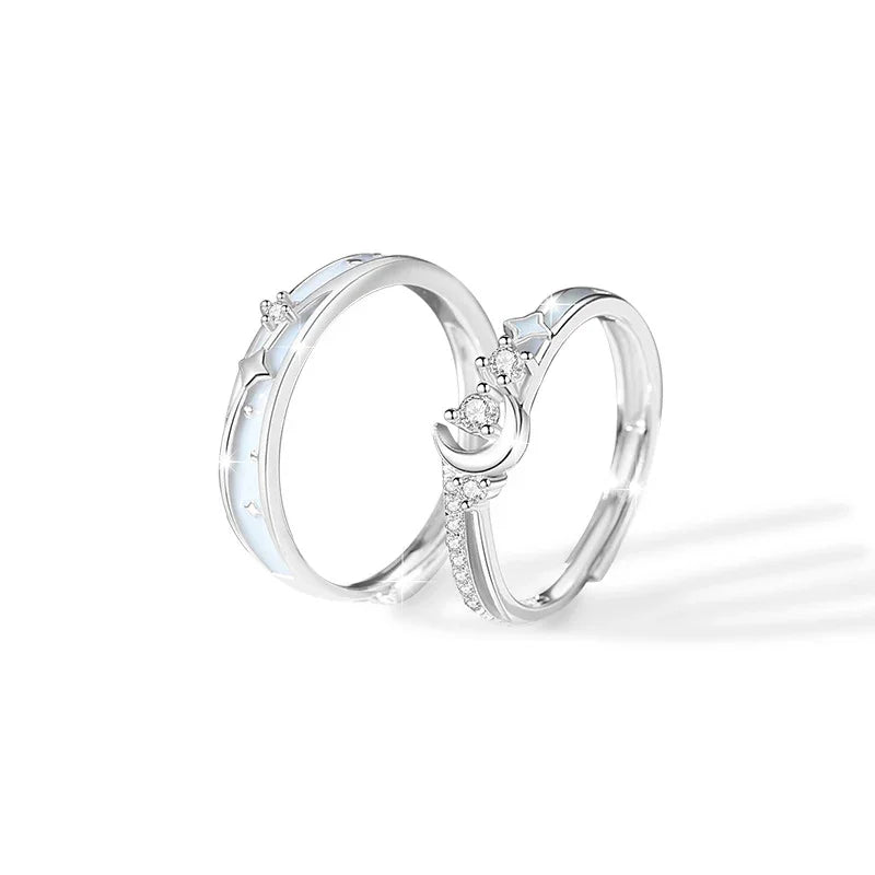A sterling silver ring with a slim band, decorated with star and small diamond-like accents along the surface, reflecting a soft shine against a white background.