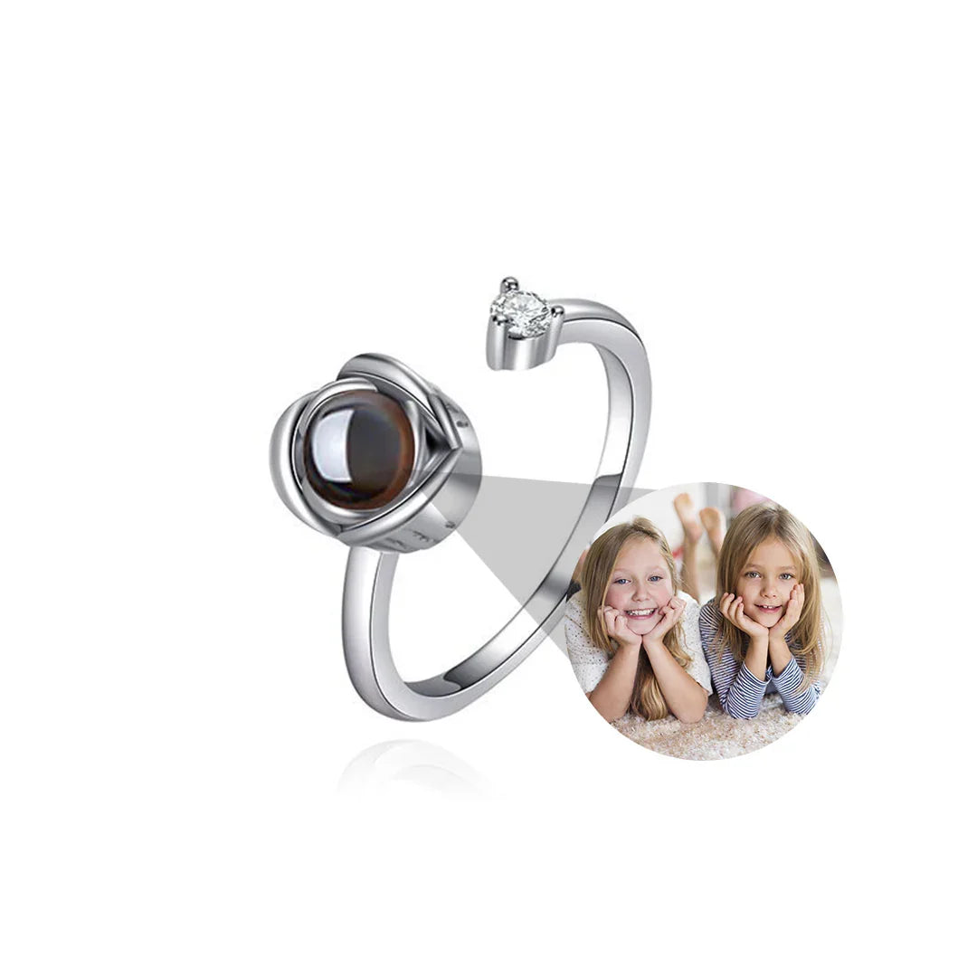 Silver ring with a brown gemstone and heart-shaped design, featuring a photo of two children.