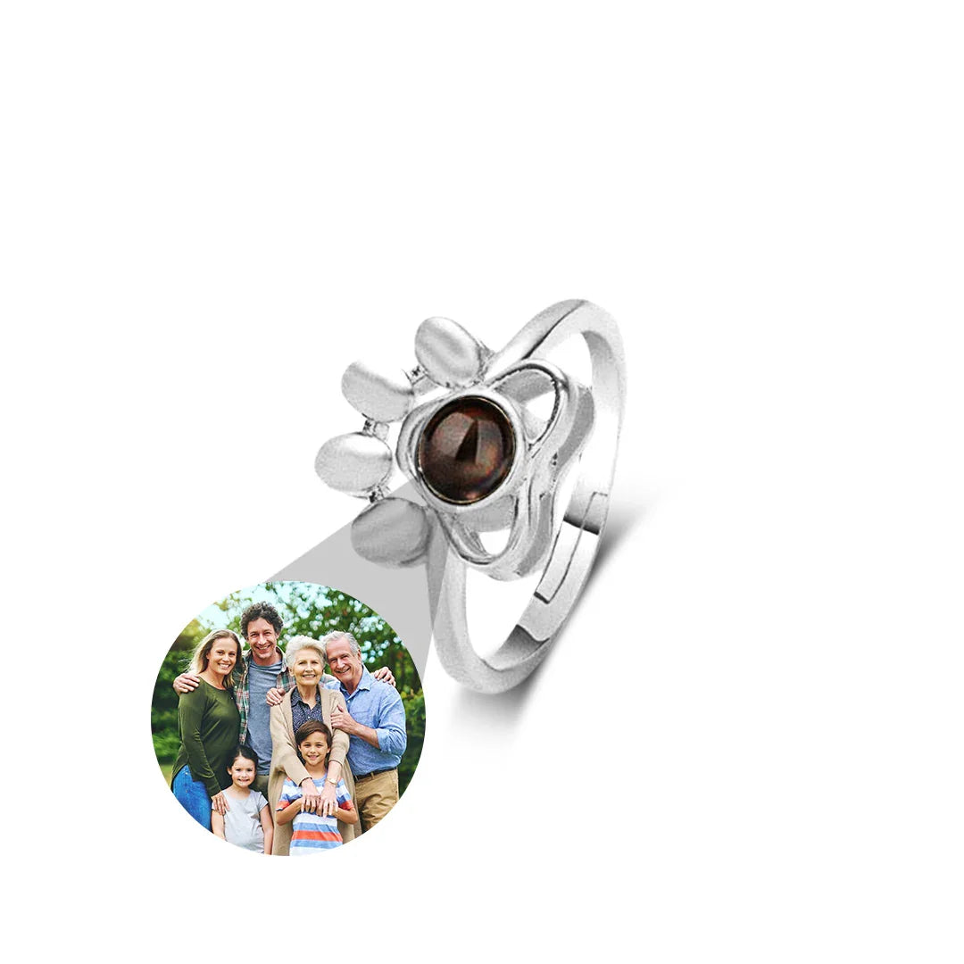 Silver ring with a sun design and a round photo insert on a white background