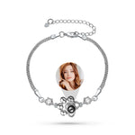 Silver bracelet with a photo charm featuring a person on a white background