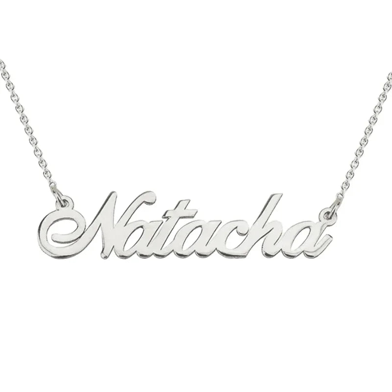 A silver personalised name necklace featuring the name “Natacha” in an elegant cursive font, attached to a delicate chain.