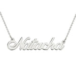 A silver personalised name necklace featuring the name “Natacha” in an elegant cursive font, attached to a delicate chain.