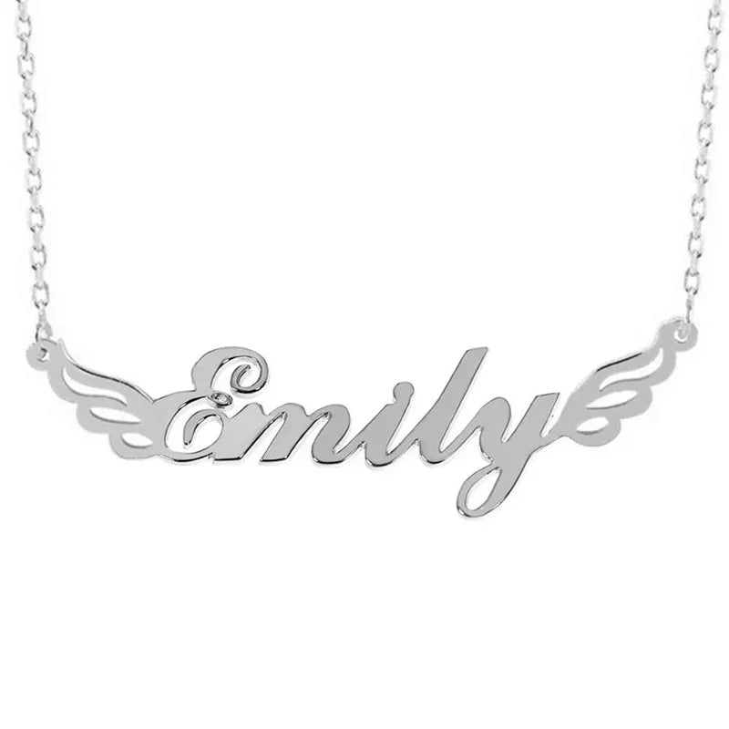 A silver name necklace featuring the word “Emily” in elegant cursive font, accented with delicate wing designs on both sides, attached to a fine chain.