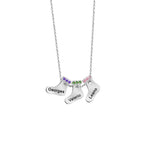 A silver necklace featuring three Christmas stocking charms, each engraved with a name and adorned with colorful birthstones along the top edges.