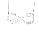 A silver infinity necklace with two small heart shapes incorporated into the design and engraved names “Selas” and “Saph” on each side. The pendant is attached to a fine silver chain, symbolizing eternal love and connection.