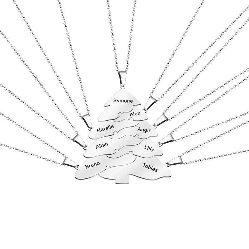 Silver Christmas tree-shaped pendant necklace composed of multiple interlocking layers, each engraved with different names, displayed on a white background.