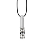 A Titanium steelmen’s necklace featuring a sleek cylindrical pendant engraved with multiple names, suspended on a black leather cord, symbolizing connection and modern minimalist style.