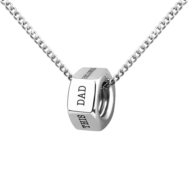A silver men’s necklace with a hex nut pendant engraved with “THIS DAD BELONGS TO.”