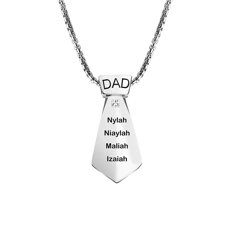 Silver tie-shaped necklace with “DAD” engraved on top and four names listed below.
