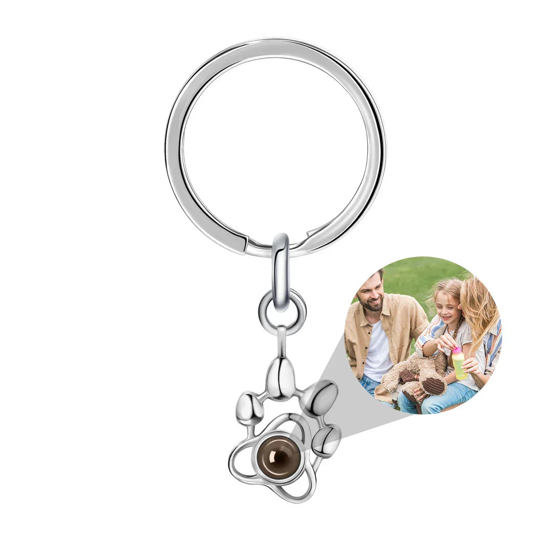 Keychain with a heart-shaped photo charm featuring a family with a dog on a white background