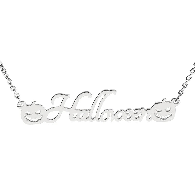A silver necklace featuring the word "Halloween" in elegant cursive lettering, with two carved pumpkin faces—one on each side of the text—adding a festive Halloween touch. 