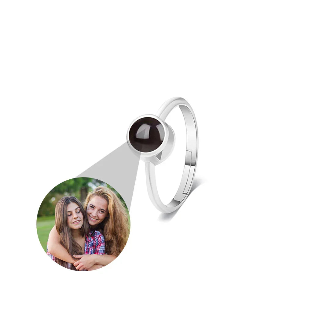 Silver ring with a circular pendant featuring a photo of two people on a white background