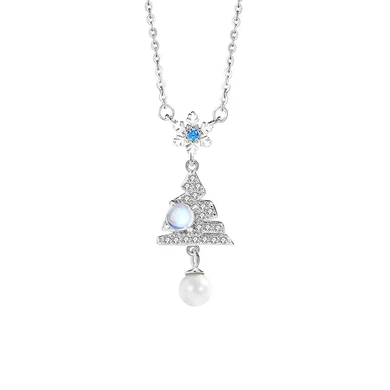 Elegant necklace with a snowflake and Christmas tree pendant featuring a blue gemstone and a pearl drop on a white background.