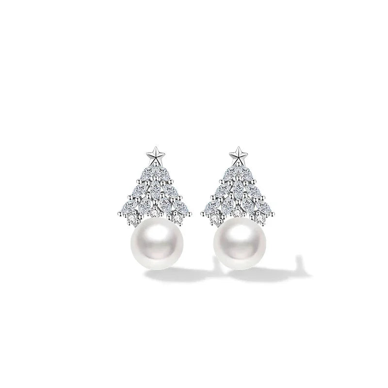 A pair of elegant Christmas tree–shaped earrings featuring sparkling crystal details, a small star on top, and a single round white pearl at the base, displayed on a clean white background.