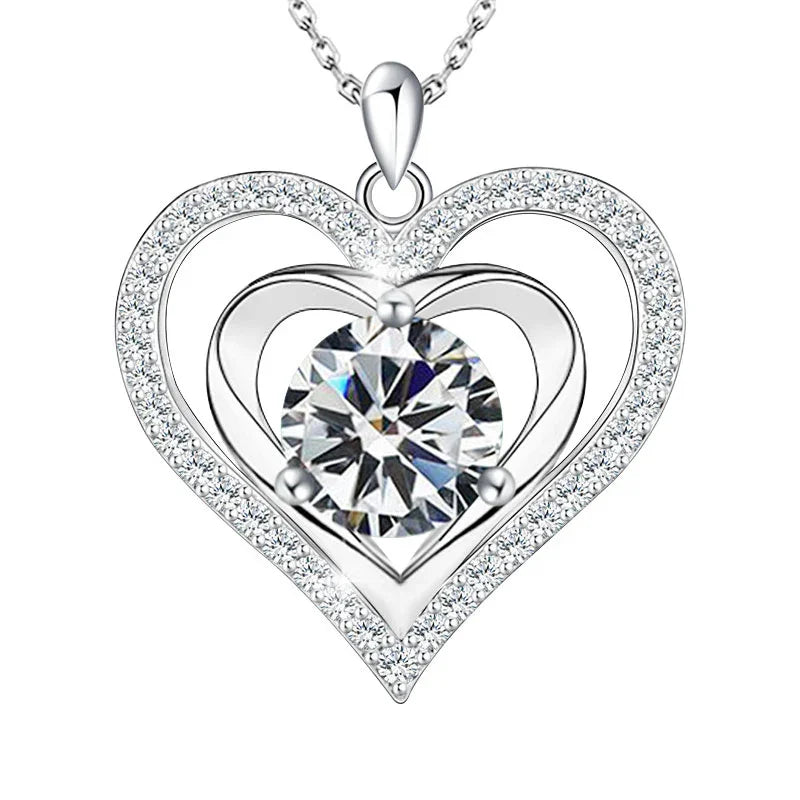 A silver double-heart necklace with a radiant round birthstone at the center, surrounded by shimmering crystals that symbolize eternal love and light.