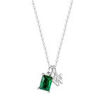 Silver necklace with a green gemstone pendant on a white background