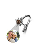 Personalized bracelet with sun design and photo charm on a white background