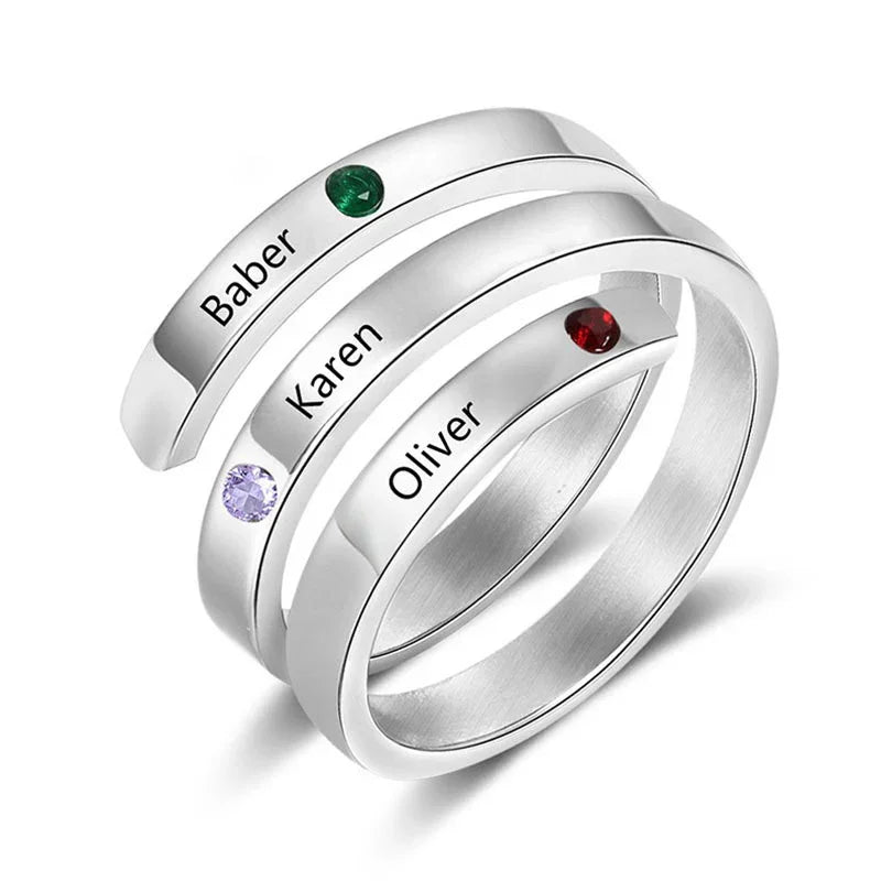 Silver triple-band ring engraved with the names “Baber,” “Karen,” and “Oliver,” each accented with a different colored birthstone.