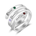 Silver triple-band ring engraved with the names “Baber,” “Karen,” and “Oliver,” each accented with a different colored birthstone.