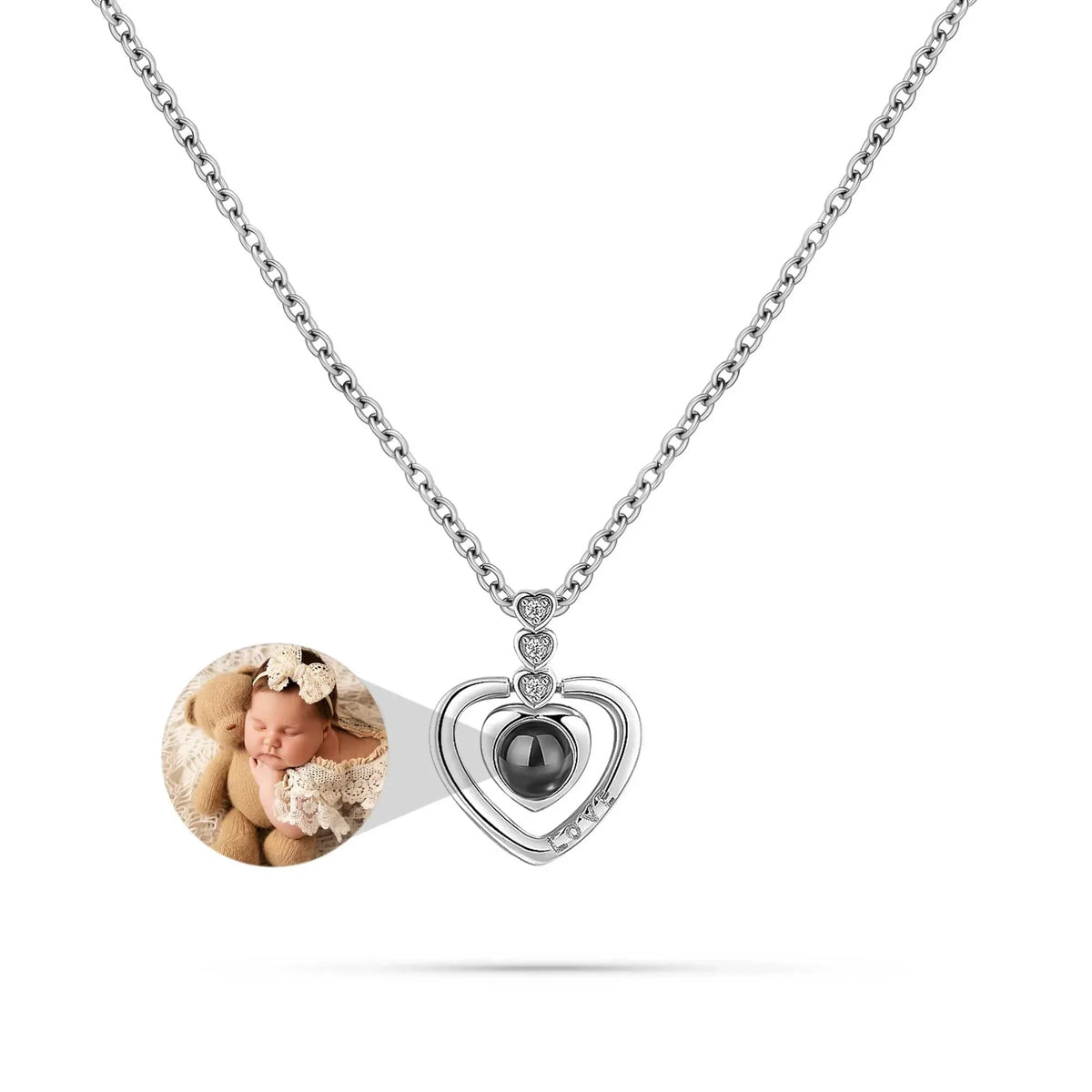 Heart-shaped pendant with photo insert on a white background