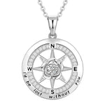 A silver compass-shaped necklace engraved with “I’d be lost without you,” featuring a central flower and sparkling crystals, symbolizing love as one’s true direction.